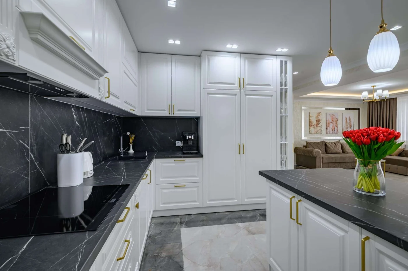 Large Black And White Expensive Well Designed Modern Kitchen In Studio Interior, Black Marble Countertop A new kitchen with black stone countertops and white cabinets